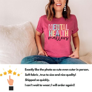 May include: A pink t-shirt with the text "MENTAL HEALTH matters" in rainbow colours. The text is in a distressed font style.