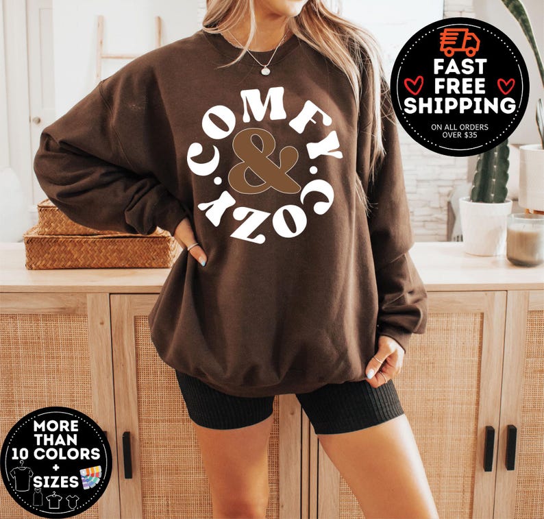 May include: Brown sweatshirt with white text that reads "Comfy & Cozy" in a retro font.