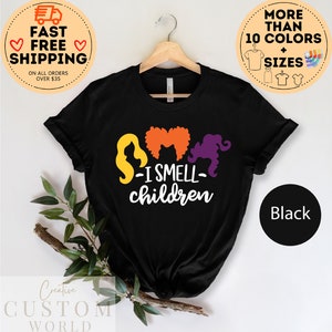 May include: Black t-shirt with a graphic of three witches with the text "S-I SMELL- children".