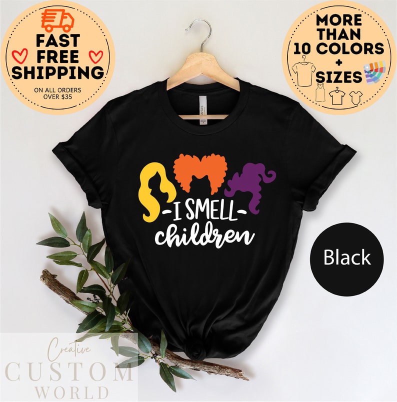 May include: Black t-shirt with a graphic of three witches with the text "S-I SMELL- children".