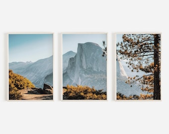 May include: A set of three framed prints featuring a scenic view of Half Dome in Yosemite National Park. The prints show different perspectives of the iconic rock formation, including a close-up of the granite face and a view from a distance with trees in the foreground.