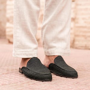 May include: Black woven leather slip-on shoes with a pointed toe.