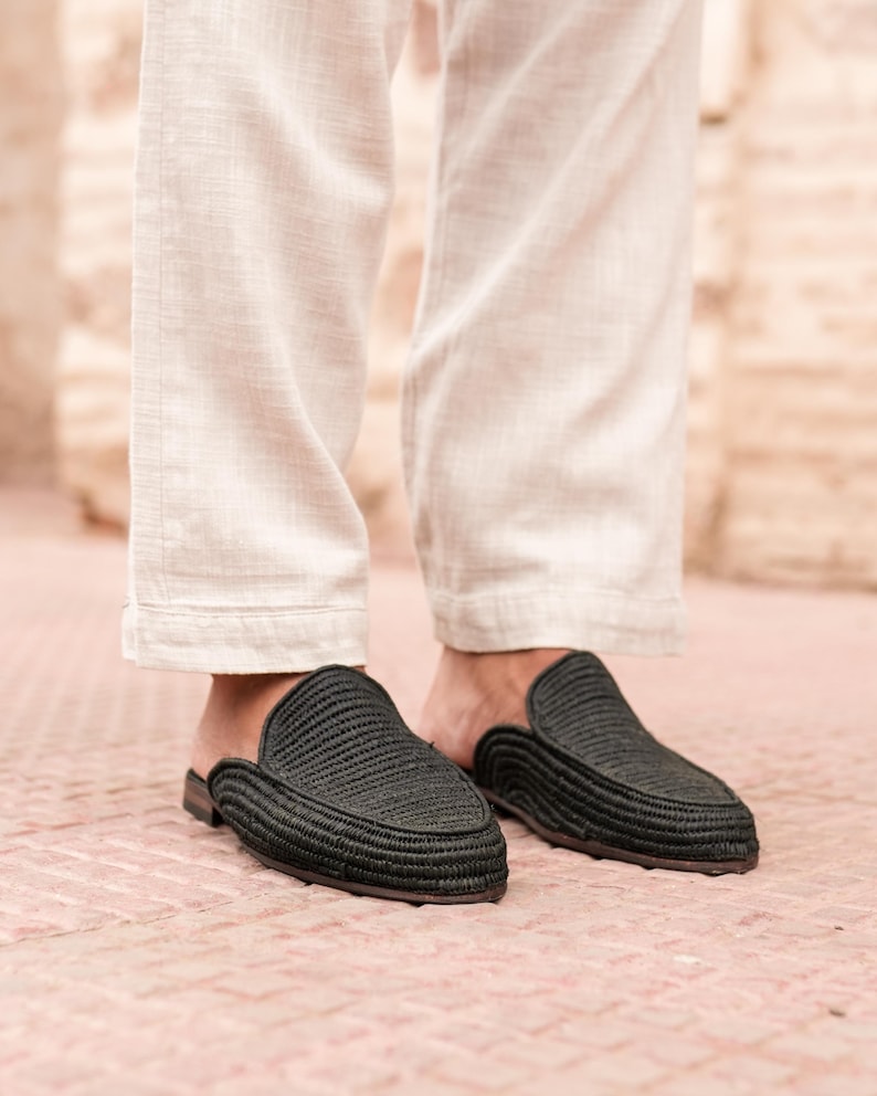 May include: Black woven leather slip-on shoes with a pointed toe.