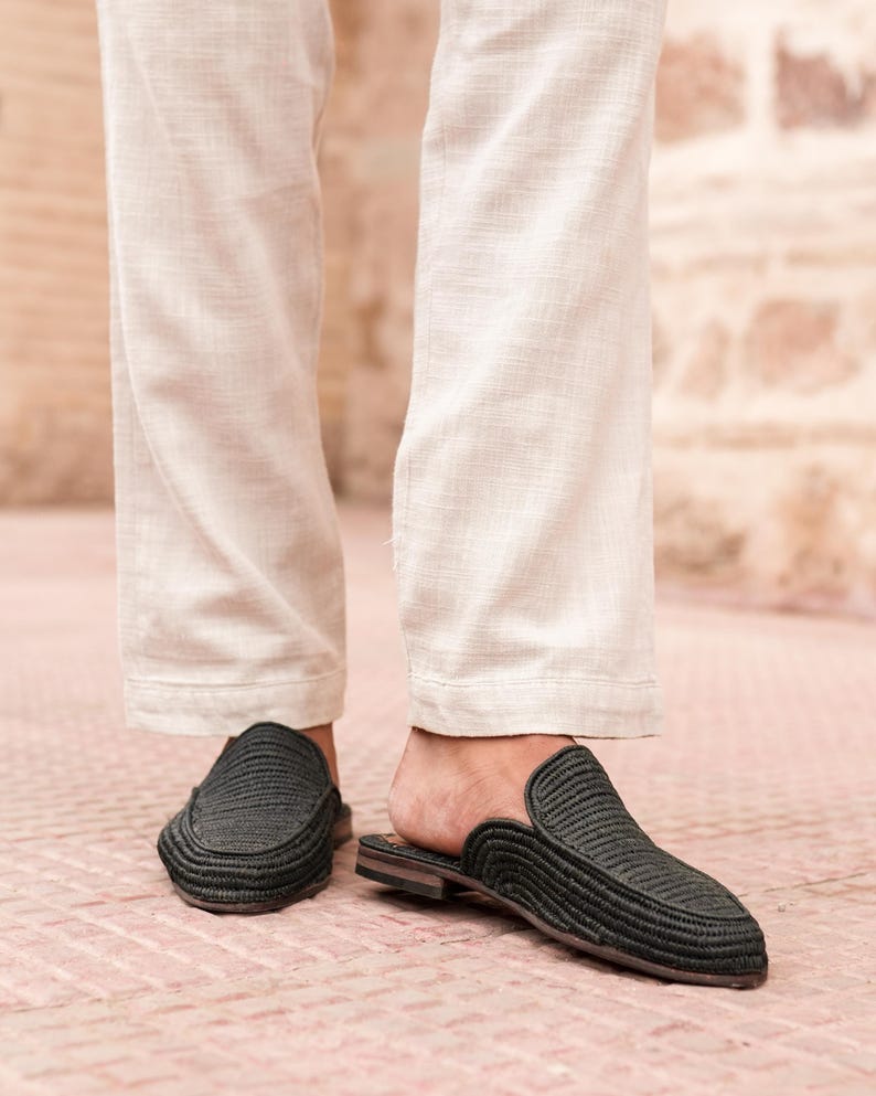 May include: A pair of black woven leather slip-on shoes with a pointed toe.