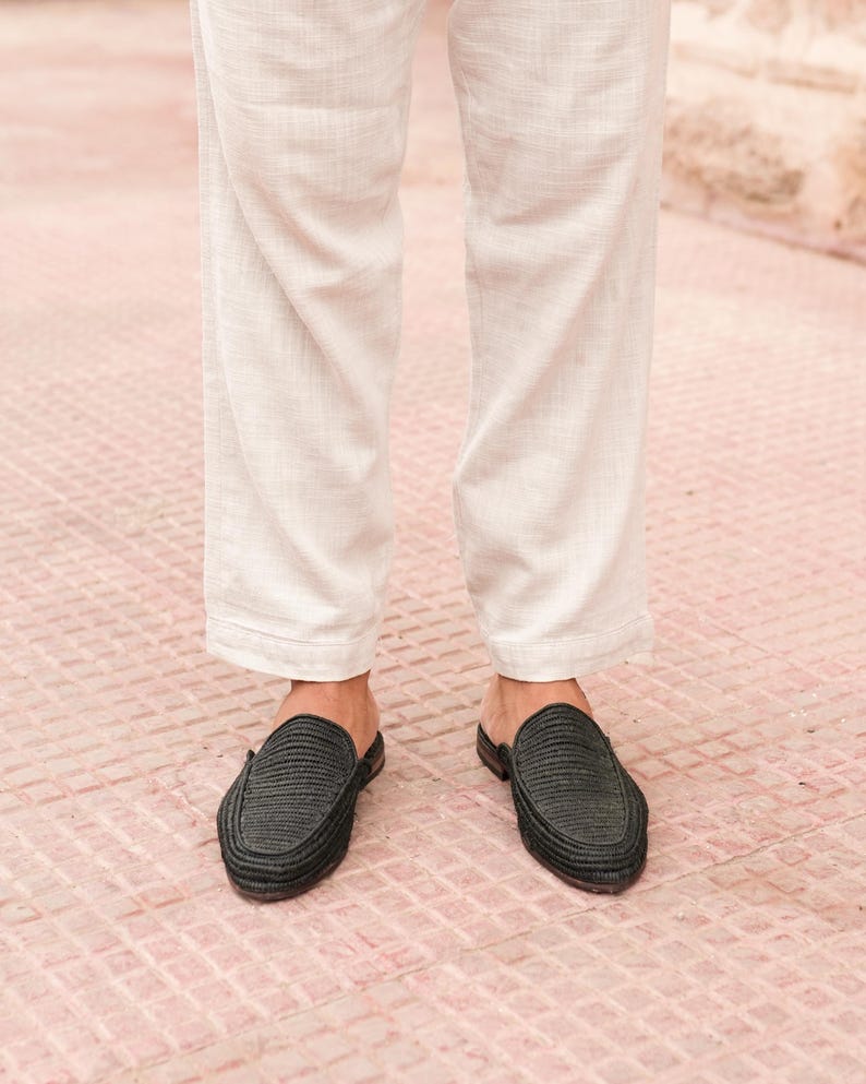 May include: A pair of black woven leather slip-on shoes with a pointed toe.