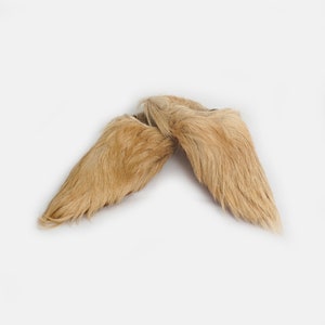 Puede incluir: Un par de pantuflas de piel marr&oacute;n con dedos puntiagudos. Las pantuflas est&aacute;n hechas de piel suave y esponjosa y son perfectas para mantener los pies calientes en invierno.