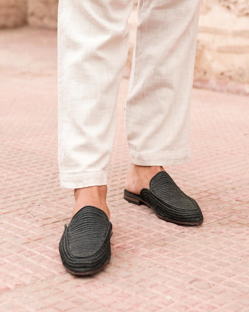 May include: A pair of black woven leather slip-on shoes with a pointed toe.