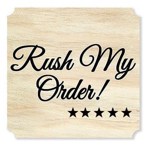 May include: A light-colored wooden sign with the words "Rush My Order!" in elegant black script. Five black stars are below the text. The sign has a decorative, scalloped edge.