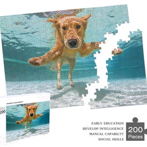 May include: A 200-piece jigsaw puzzle featuring a golden retriever dog swimming underwater in a pool. The puzzle is made of cardboard and has a blue and white background.