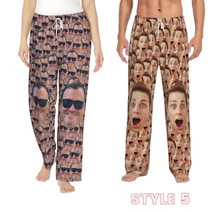 May include: A pair of brown pyjama trousers with a pattern of repeated faces. The trousers have an elastic waistband and a drawstring.