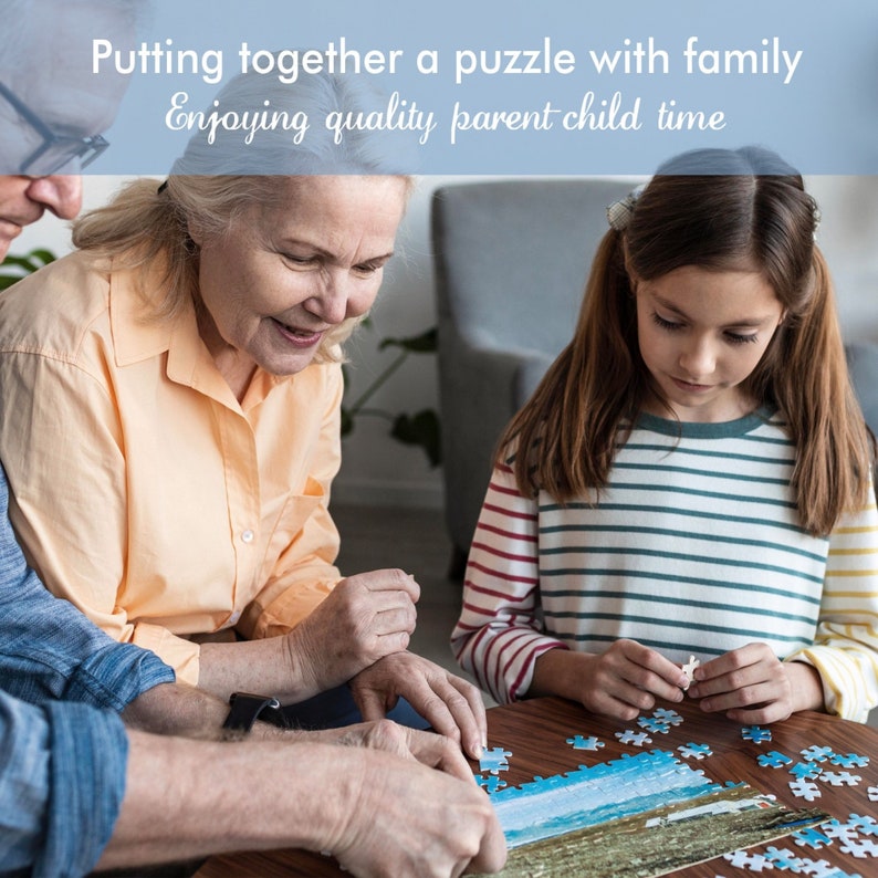 May include: A family of three working together on a large jigsaw puzzle. The puzzle is on a wooden table and shows a scenic landscape. The family is enjoying quality time together.