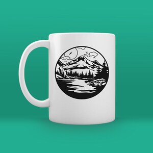May include: White ceramic mug with a black and white illustration of a mountain scene with a lake, trees, and clouds. The illustration is in a circle.