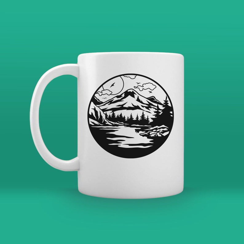 May include: White ceramic mug with a black and white illustration of a mountain scene with a lake, trees, and clouds. The illustration is in a circle.
