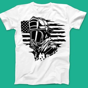May include: A white t-shirt featuring a black and white graphic of a firefighter wearing a helmet and gas mask in front of an American flag.