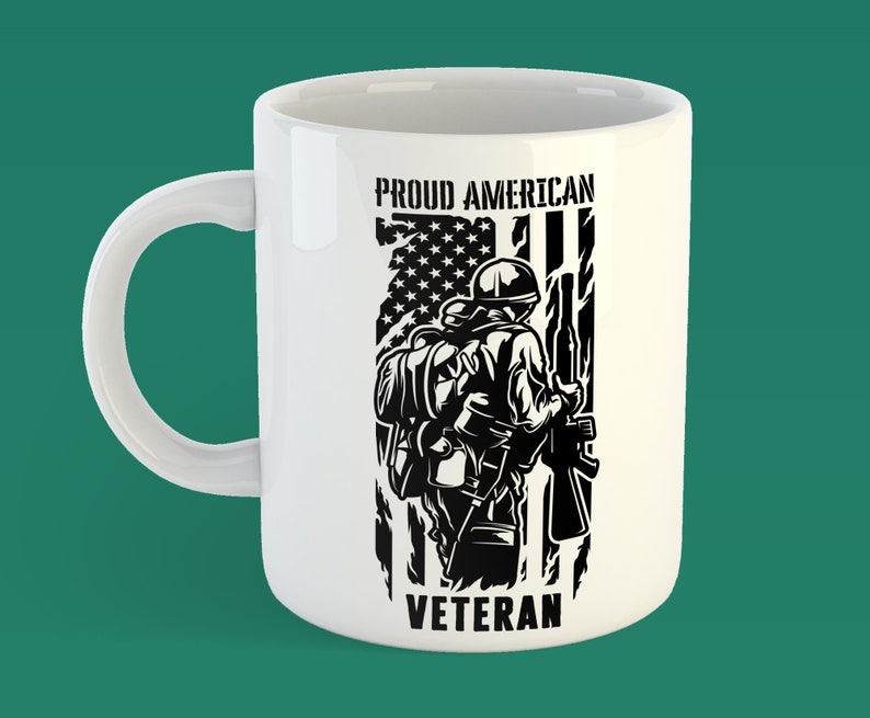 May include: White ceramic mug with a black and white graphic of a soldier standing in front of an American flag. The text "Proud American Veteran" is printed on the mug.