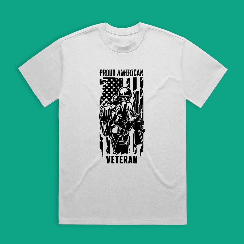 May include: White t-shirt with a black and white graphic of a soldier standing in front of an American flag. The text "Proud American Veteran" is printed on the shirt.