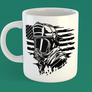 May include: White ceramic mug featuring a black and white illustration of a firefighter wearing a helmet and a gas mask. The firefighter is standing in front of an American flag.