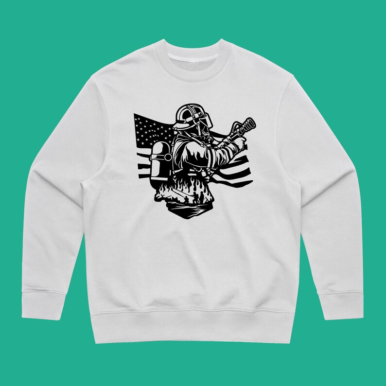 May include: White sweatshirt with a black and white illustration of a firefighter holding a hose in front of an American flag.