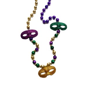May include: Mardi Gras beaded necklaces in green, gold, and purple. Each necklace features a glittery mask pendant. The beads are round and vary in size. The necklaces are displayed against a white background.