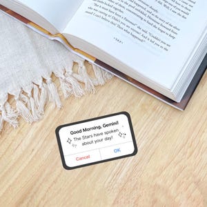 a sticker reminiscent of an iPhone alert, but it says, good morning, Gemini or other zodiac sign, the stars have spoken about your day! in reference to zodiac academy perfect for adding bookish flair to your kindle or laptop