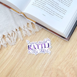 a sticker with the quote you could rattle the stars with purple and blue texture and four pointed stars, a quote by nehemia ytger, Aelins best friend from throne of glass by Sarah j Maas
