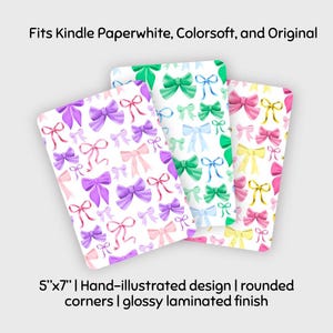 May include: Three rectangular protective covers with rounded corners and a glossy laminated finish, featuring a hand-illustrated pattern of colorful bows. Text reads: Fits Kindle Paperwhite, Colorsoft, and Original. 5"x7" | Hand-illustrated design | rounded corners | glossy laminated finish.