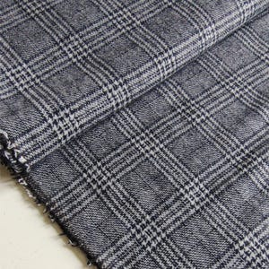 May include: A set of three ceramic mugs with a speckled, matte finish. The mugs are in shades of cream, light brown, and dark brown. Each mug has a simple, minimalist design and a rounded handle.