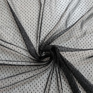 May include: Black sheer fabric with a polka dot design. The fabric is draped, creating folds and shadows. The dots are evenly spaced across the material, adding texture and visual interest. Suitable for clothing and craft projects.