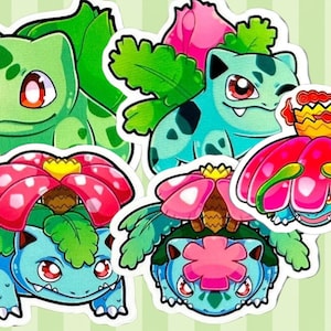 May include: A collection of five die-cut vinyl stickers featuring cartoon creatures in various stages of evolution. The designs include green and blue figures with large red eyes, leafy green foliage, and vibrant pink flowers with yellow centers.