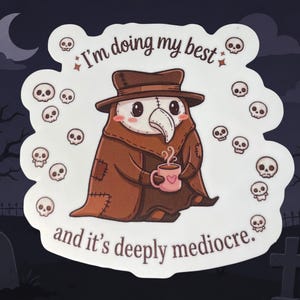 May include: A sticker featuring a cartoon plague doctor in brown robes and a hat, holding a pink mug with a heart. The text reads, "I'm doing my best and it's deeply mediocre." Small skulls surround the character.