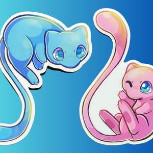 May include: Two die-cut stickers featuring stylized feline creatures. One sticker shows a light blue creature with large blue eyes and a long tail. The second sticker shows a pink creature with large blue eyes, a long tail, and a winking expression.