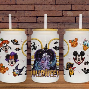 May include: Three white glass tumblers with bamboo lids and straws, decorated with Halloween-themed Disney character graphics. The designs include Mickey Mouse, Minnie Mouse, Donald Duck, Goofy, and Ursula, with the word "Halloween" on one.