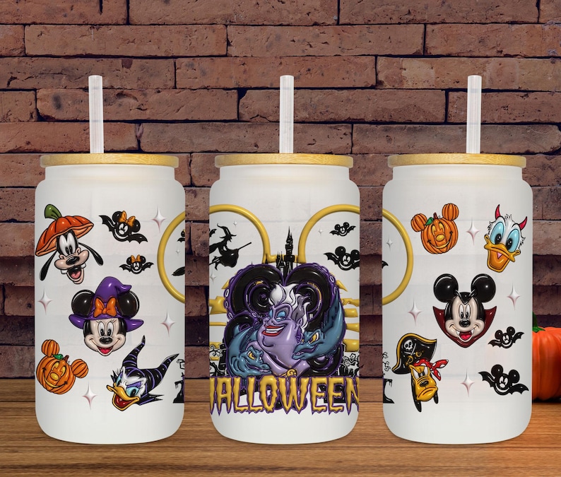 May include: Three white glass tumblers with bamboo lids and straws, decorated with Halloween-themed Disney character graphics. The designs include Mickey Mouse, Minnie Mouse, Donald Duck, Goofy, and Ursula, with the word "Halloween" on one.