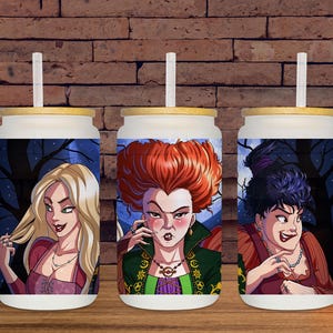 May include: Three white glass tumblers with bamboo lids and straws. Each tumbler features a colorful illustration of a character from a Halloween-themed movie. The background of each tumbler shows a dark forest scene.