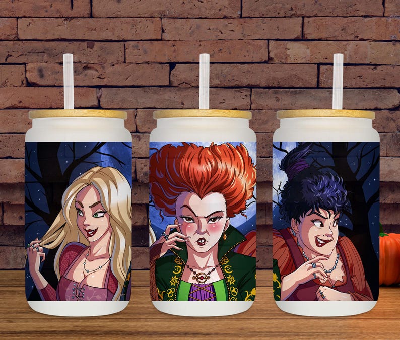 May include: Three white glass tumblers with bamboo lids and straws. Each tumbler features a colorful illustration of a character from a Halloween-themed movie. The background of each tumbler shows a dark forest scene.