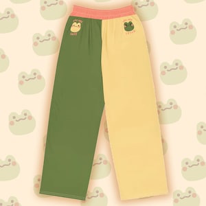 May include: Green and yellow trousers with a frog graphic and the text "You are safe" on the left leg and "You are loved" on the right leg.