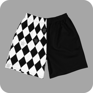 May include: Black and white checkered shorts with a black solid panel on the right side. The checkered side has a diamond pattern with small crown designs.