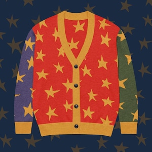 May include: A red button-down cardigan with a pattern of yellow stars. The sleeves are colour-blocked in purple and green. The trim and neckline are yellow. The sweater has black buttons.