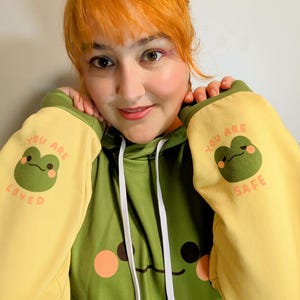Friendly Frog Unisex Hoodie | You are safe You are loved text on the sleeves