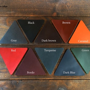May include: Leather color samples in the shape of triangles. The colors are: gray, black, dark brown, brown, caramel, red, bordo, turquoise, dark blue, and green.