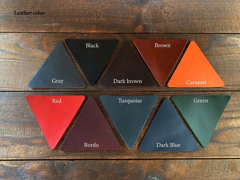 May include: Leather color samples in the shape of triangles. The colors are: gray, black, dark brown, brown, caramel, red, bordo, turquoise, dark blue, and green.
