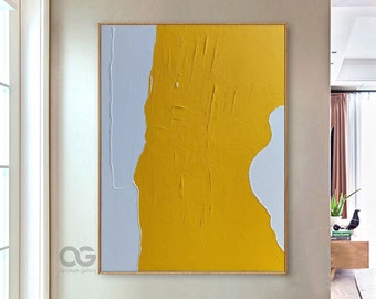 May include: Abstract painting with a yellow and gray color scheme. The painting is on a canvas and has a textured surface. The painting is hanging on a wall in a room with a wooden floor.
