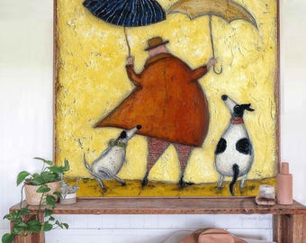 May include: A whimsical painting depicts a person in a long orange coat holding two umbrellas, with two dogs. The background is textured yellow. The artwork is framed in a wooden frame and rests on a wooden bench.