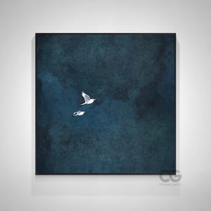 May include: Framed artwork depicting two white seagulls soaring against a dark blue, textured backdrop. The image has a watercolour effect, with subtle variations in the blue tones. The frame is black, and the overall aesthetic is tranquil and calming.