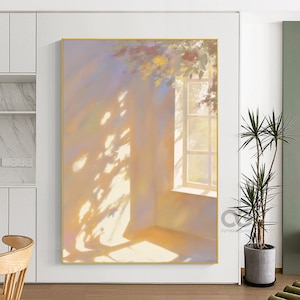May include: A framed painting of an interior scene bathed in sunlight. The artwork shows a window with light streaming through, creating shadows on the wall. The colour scheme is soft, with warm yellows and oranges. The painting is presented in a gold frame.