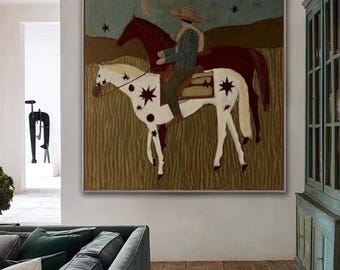 May include: A square painting in a thin frame depicts a person in a hat riding a white horse with dark star markings. A dark brown horse stands behind them in a field under a blue sky with stars. The scene is rendered in muted earth tones.