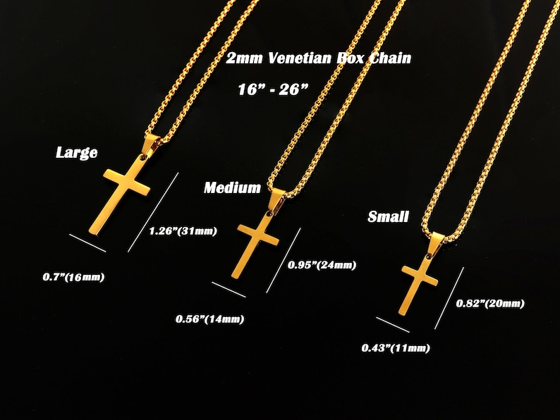 May include: Three gold cross pendants on chains, with measurements in inches and millimeters. The largest cross is 1.26 inches (31 millimeters) tall and 0.7 inches (16 millimeters) wide. The medium cross is 0.95 inches (24 millimeters) tall and 0.56 inches (14 millimeters) wide. The smallest cross is 0.82 inches (20 millimeters) tall and 0.43 inches (11 millimeters) wide. The chains are 2mm Venetian box chains.