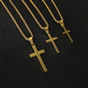 May include: Three gold chains with cross pendants. The cross pendants have different inscriptions: "Our love for you never ends", "Isaiah 41:10", and a third inscription that is not visible in the image.