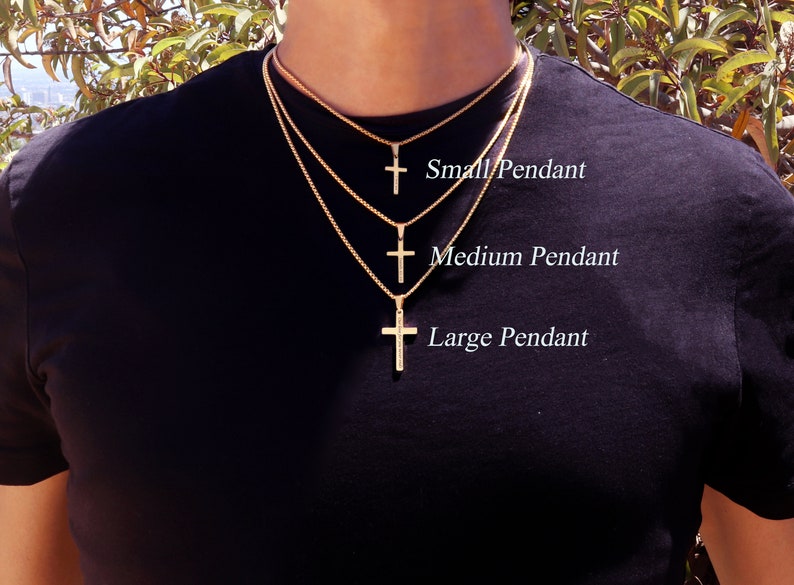 May include: Three gold chain necklaces with cross pendants of different sizes. The smallest cross is labeled "Small Pendant", the middle cross is labeled "Medium Pendant", and the largest cross is labeled "Large Pendant".