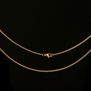 May include: A gold chain necklace with a lobster clasp closure. The chain is made of small, round links.